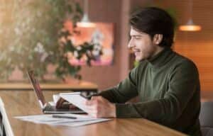 Journalist working on new article online at cafe