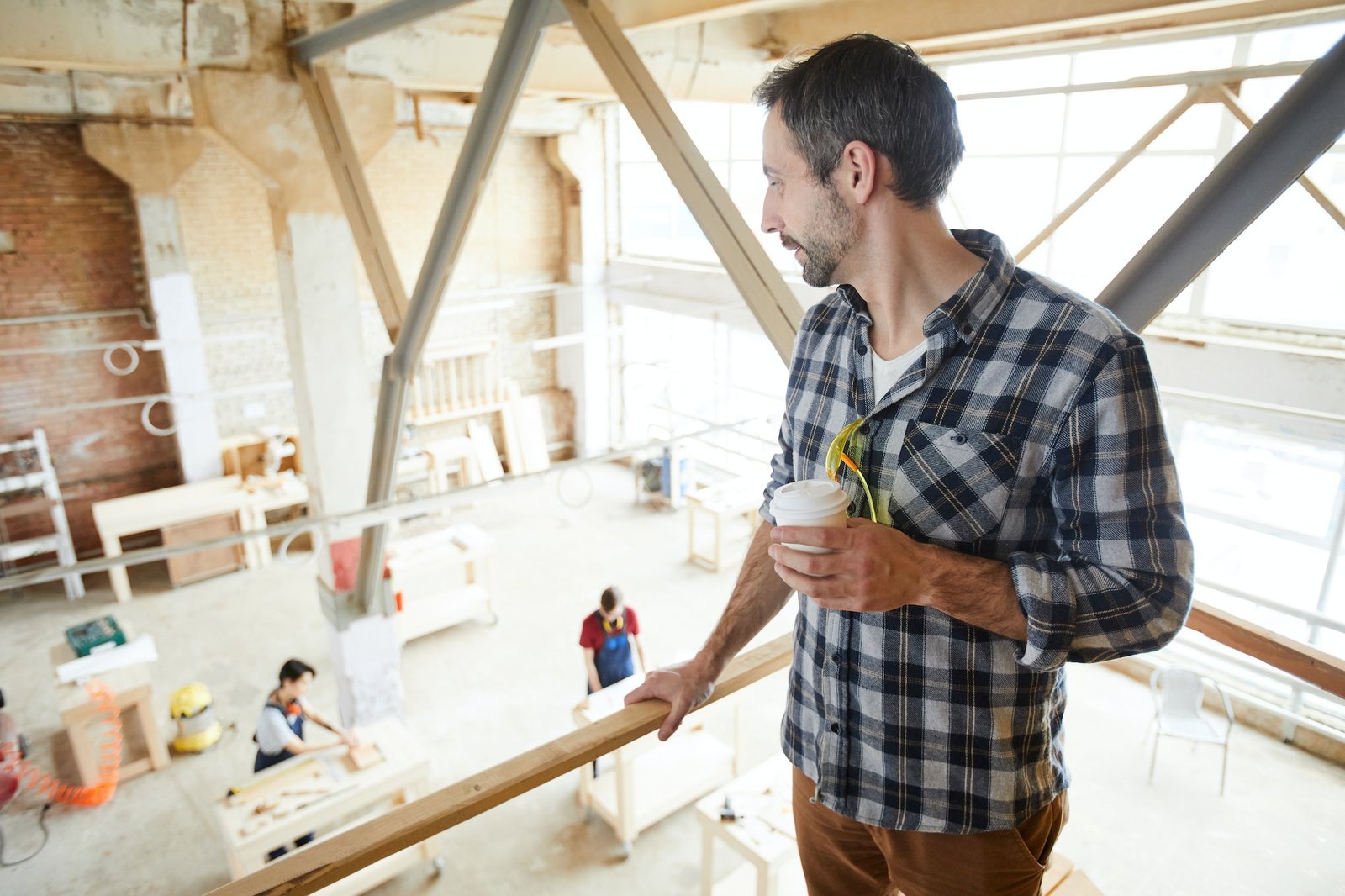 Chief carpenter observing work of joiners
