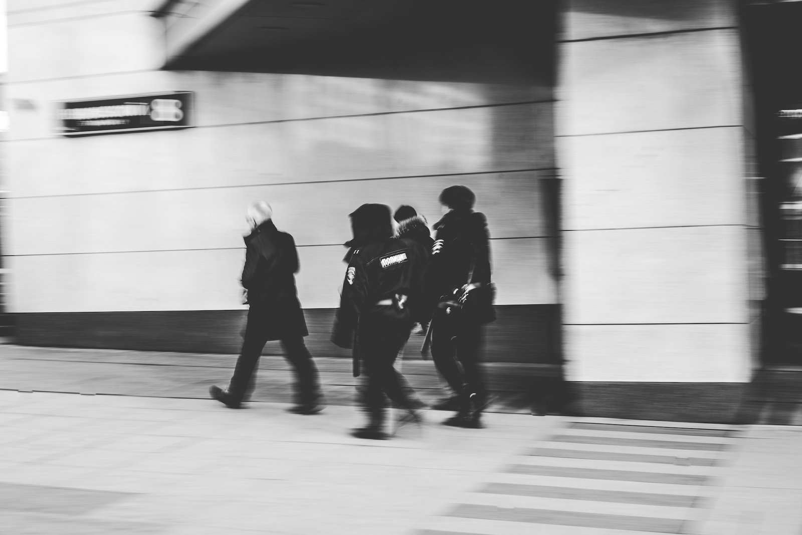 People in motion walking fast on the street